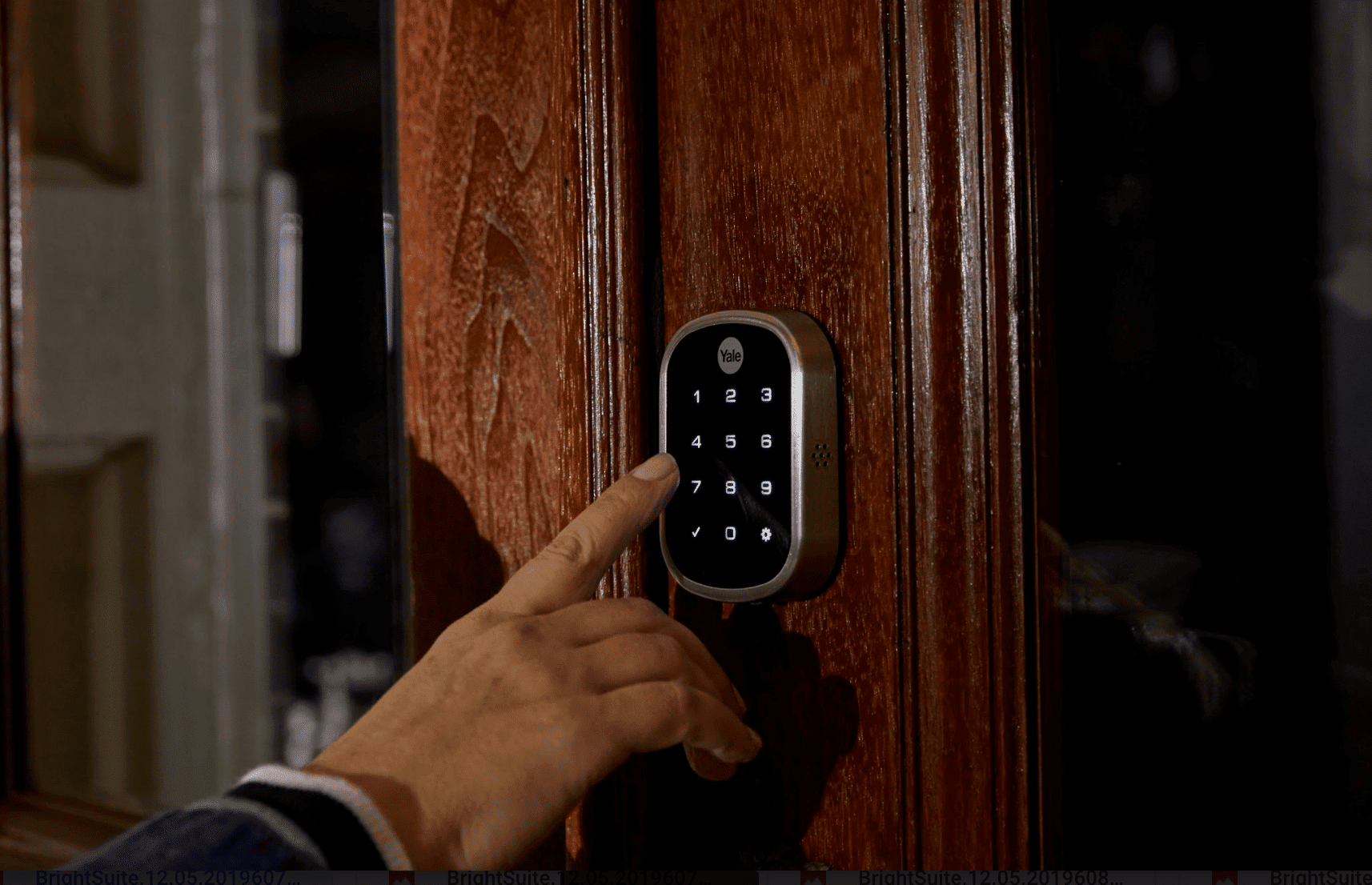 smart lock security device on a slightly open front door.