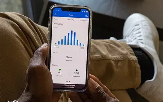 looking at solar monitoring app on mobile phone