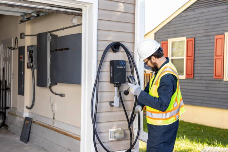 Technician installing an EV charger on a home