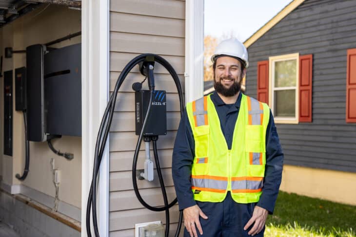 Professional installing EV charger on residential home