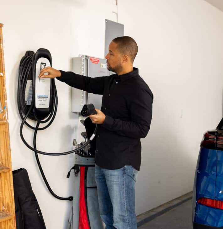 man using level 2 charger at home