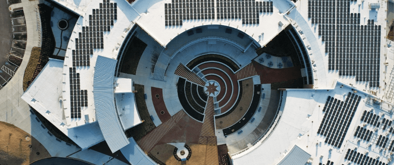 Aerial view of solar panels on unique building shape roof in Virginia